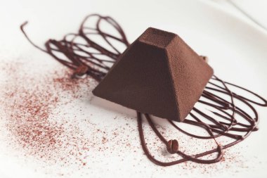 Chocolate truffle cake in pyramid shape clipart
