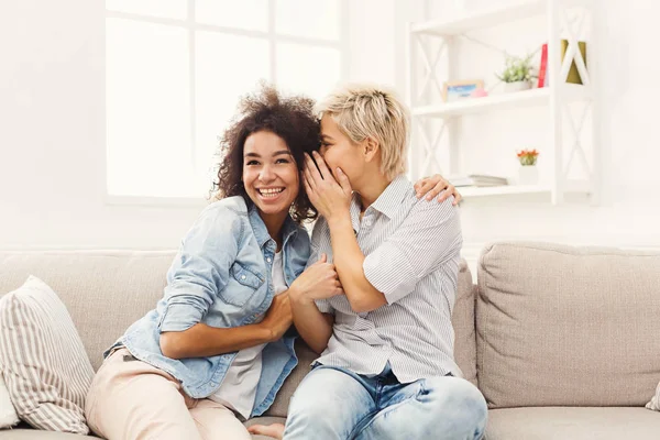 Young woman telling her friend some secrets — Stock Photo, Image