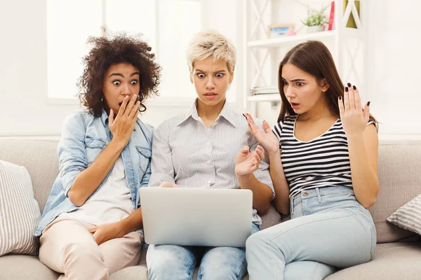 Drei schöne schockierte Frauen mit Laptop zu Hause — Stockfoto