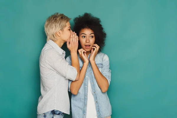 Young woman telling her friend some secrets — Stock Photo, Image