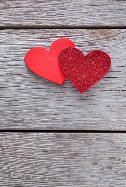 Valentine background with handmade glitter hearts on rustic wood — Stock Photo, Image