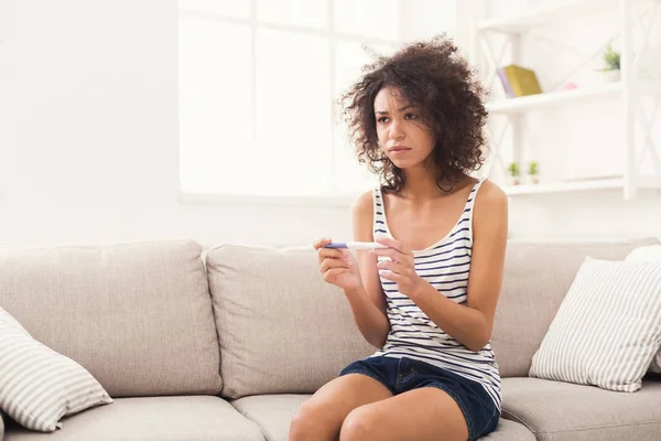 Upset black girl with negative pregnancy test — Stock Photo, Image