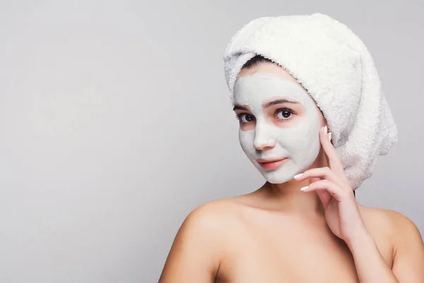 Beautiful girl with applied clay mask at white background — Stock Photo, Image