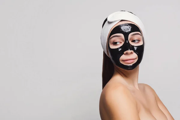 Młoda dziewczyna z czarna Maska Oczyszczająca — Zdjęcie stockowe