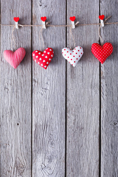Valentine day background, pillow hearts border on wood