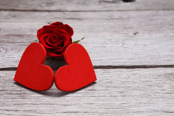 Valentine day background, handmade hearts on wood with rose