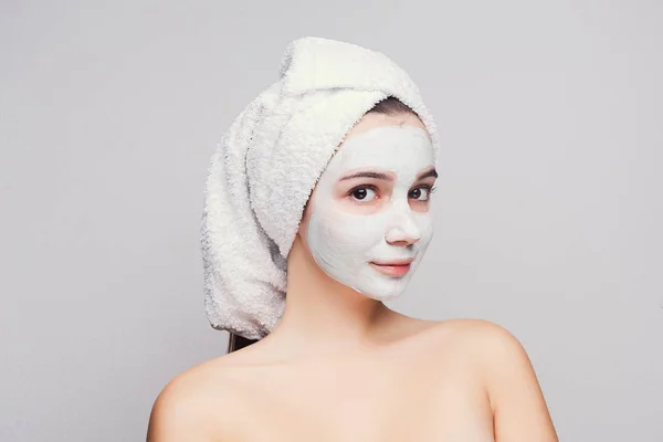 Beautiful girl with applied clay mask at white background — Stock Photo, Image