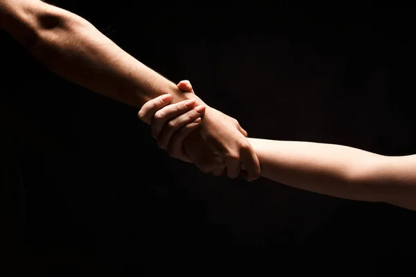 Hands of man and woman in love, isolated on black — Stock Photo, Image