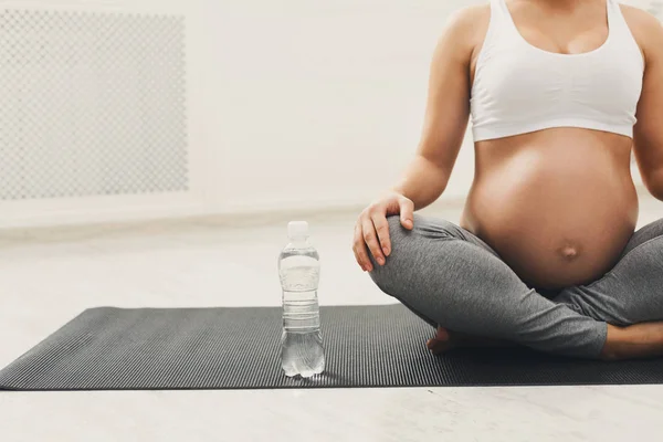 Mulher grávida irreconhecível com garrafa de água — Fotografia de Stock