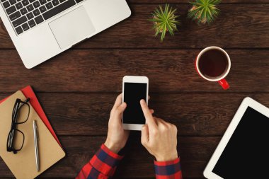 Holding bir smartphone, üstten görünüm eller mans