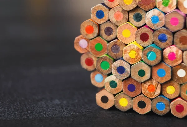 Stack of colorful pencils tips, art background