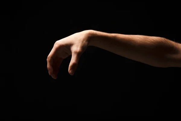 Mão masculina pegando algo, recorte em preto — Fotografia de Stock
