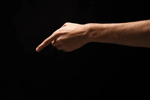 Les gestes de la main - l'homme pointant, isolé au noir — Photo