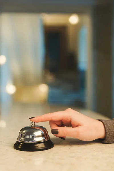 Woman ringing hotel reception service bell closeup — Stock Photo, Image