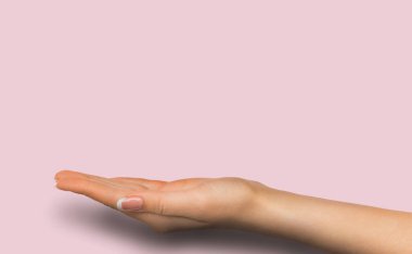 Outstretched female hand over pink background clipart