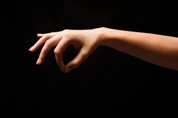 Ženská ruka něco, výřez na černé — Stock fotografie