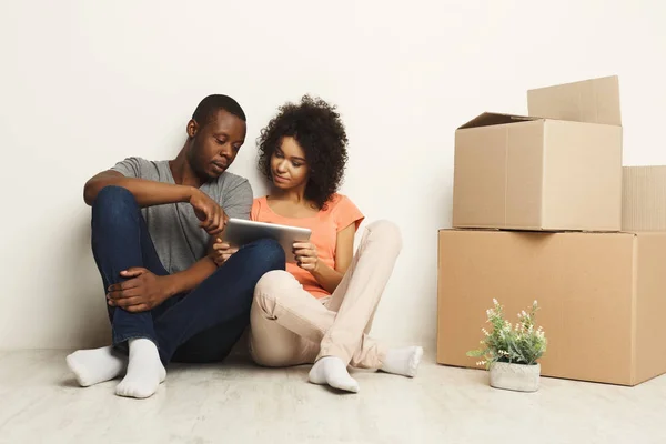 African-american sitting on floor at new appartment