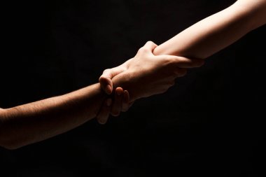 Hands of man and woman in love, isolated on black clipart