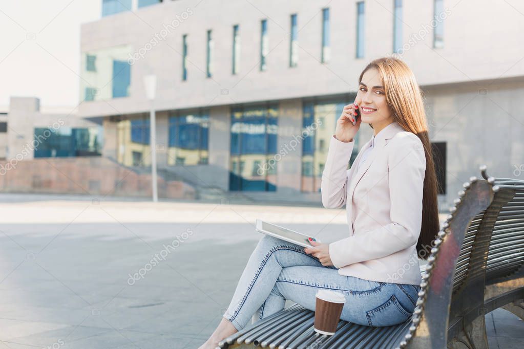 Caucasian businesswoman working with papers outdoors