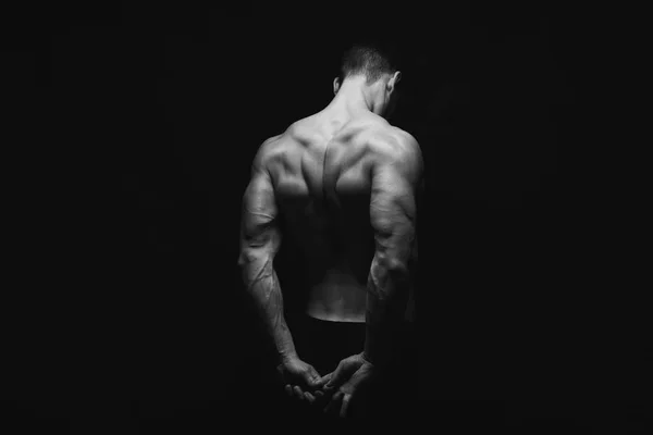 Unrecognizable man shows strong back muscles closeup — Stock Photo, Image