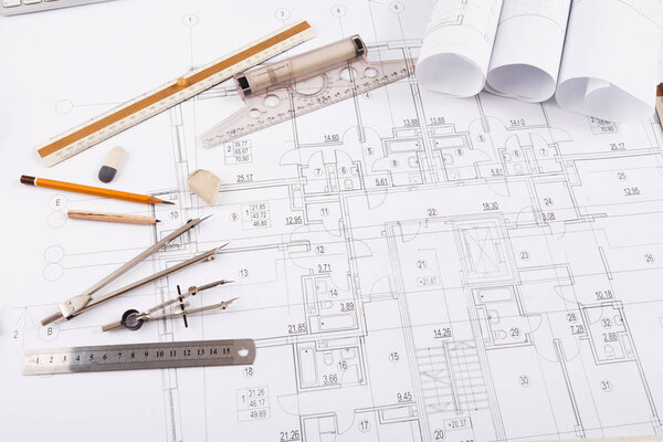 Architectural project, engineering tools on table.