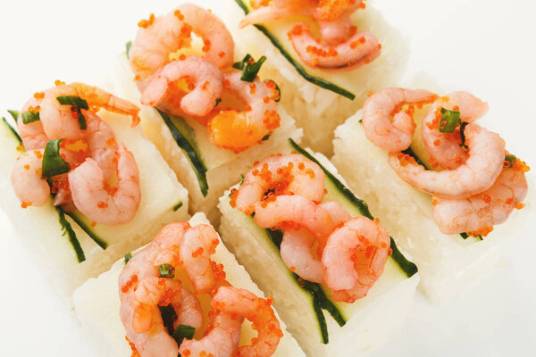 Set of rolls with soft cheese and shrimps on top, isolated