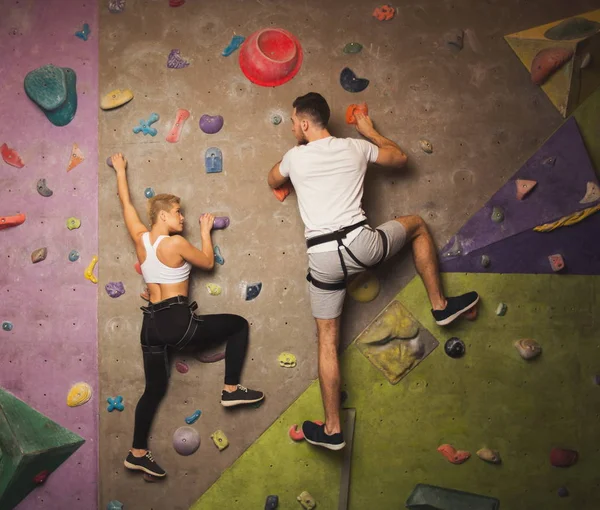 Two professionals climbing artificial rock wall at gym — Stock Photo, Image