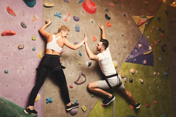 Two professionals climbing artificial rock wall at gym — Stock Photo, Image