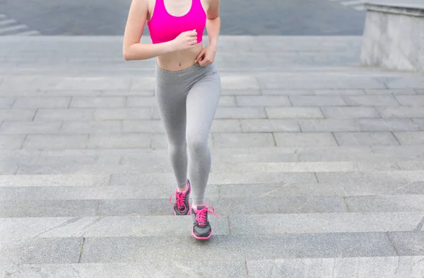 Young woman running in city copy space — Stock Photo, Image