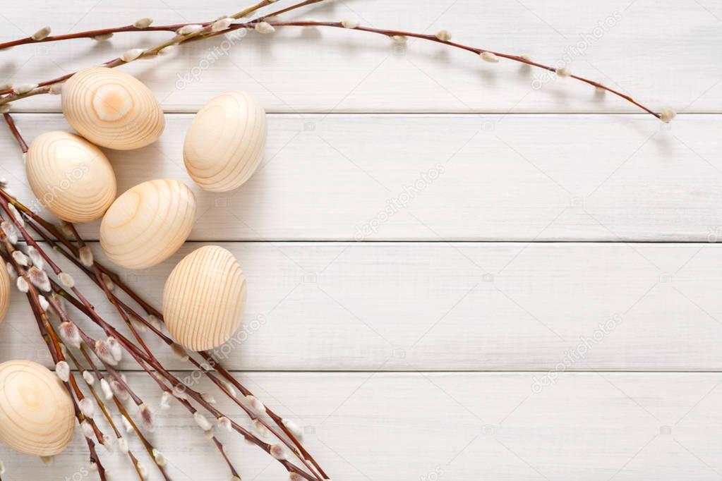 Wooden easter eggs on white wood background