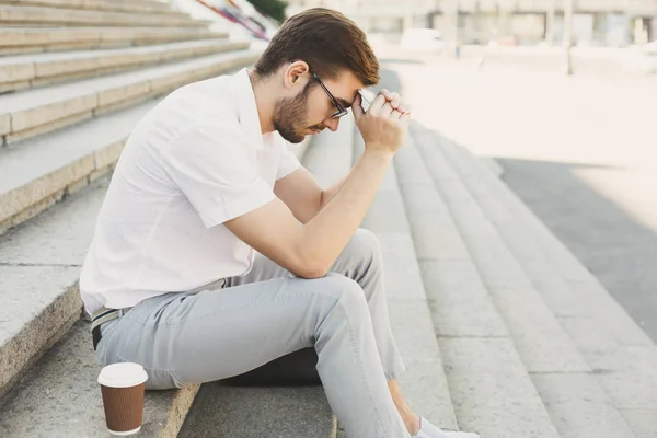 Depressed businessman with hands on head on stairs — Stock Photo, Image