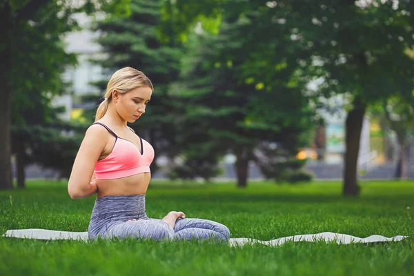 Young woman outdoors, Reverse Prayer Pose