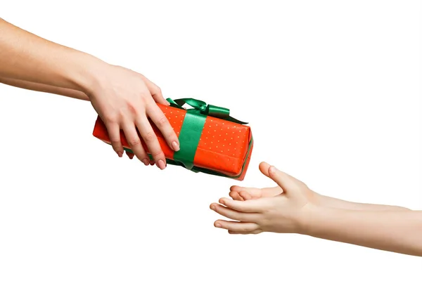Female hand give present to kid, isolated on white — Stock Photo, Image