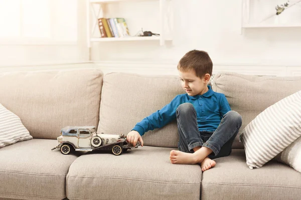 Little boy playing with toy car at home — Stock Photo, Image