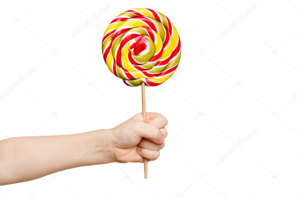 Childs hand holding big colorful lollipop