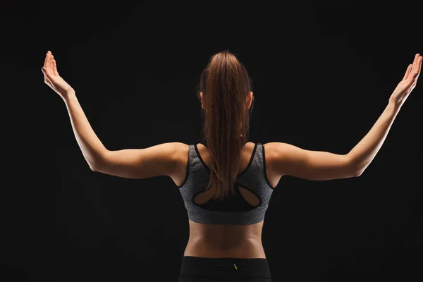 Sportovní žena ukazuje svalnaté tělo — Stock fotografie