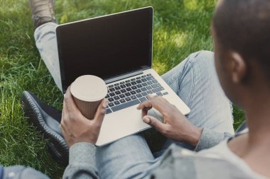 Açık havada omuz üzerinden laptop ve kahve closeup ile erkek el vurdu