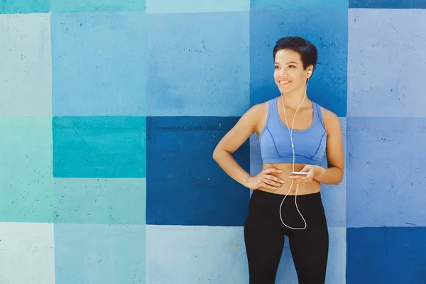 Woman choose music to listen during workout
