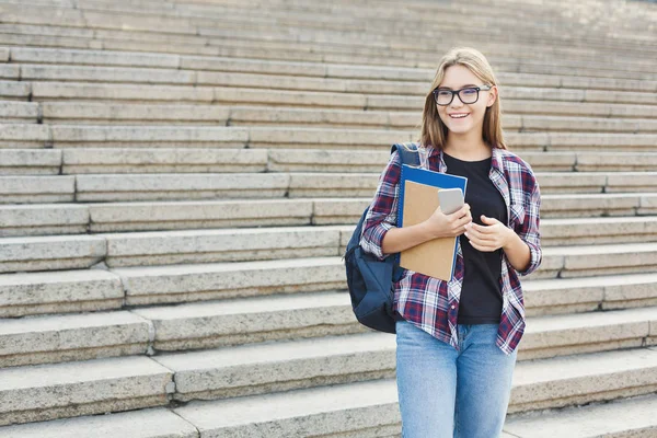 Student girl with books on university background — Stock Photo, Image