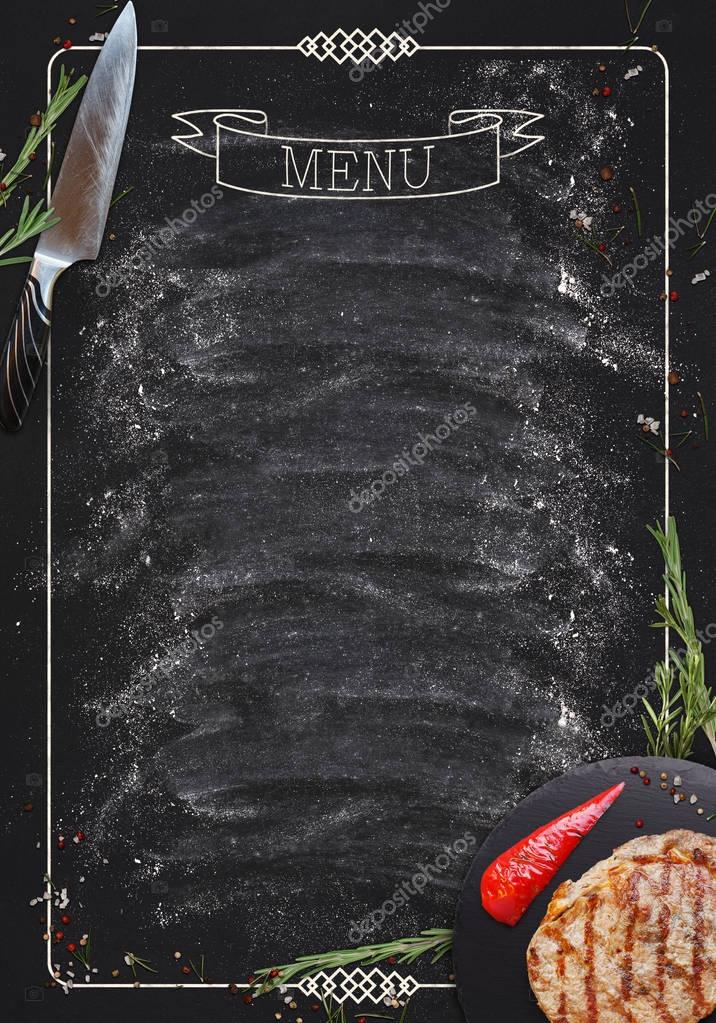 Design concept for restaurant meat and grill menu mockup. Black rustic chalkboard with white inscription and frame, top view, copy space for text and logo