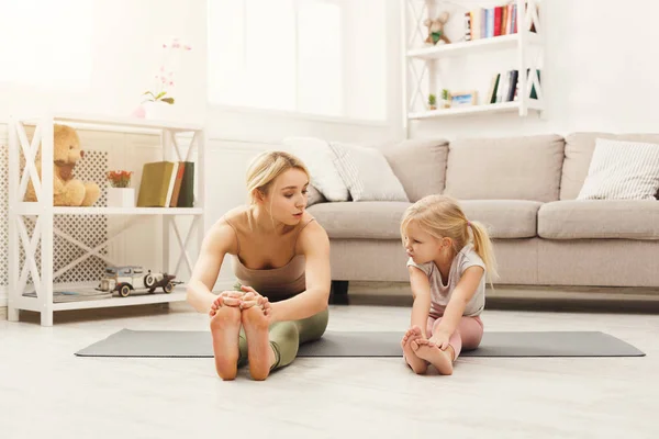 Happy mother and daughter having training at home — Stock Photo, Image