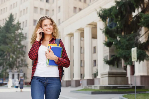 Vacker kvinnlig student står framför universitetets campus — Stockfoto