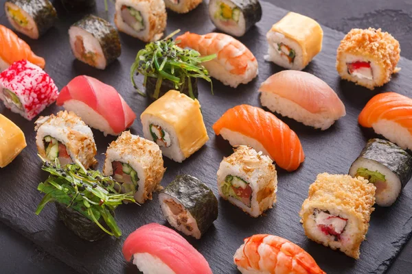 Set of sushi maki and rolls on gray background — Stock Photo, Image