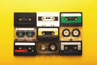 Vintage audio cassettes on yellow background clipart