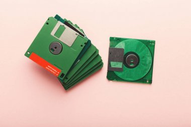 Retro floppy disks isolated on pink background clipart