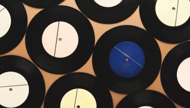 Old retro vinyl records on beige background, top view clipart