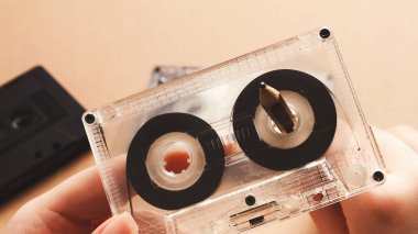 Vintage cassette and pencil to rewind tape on brown background clipart