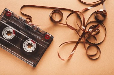 Vintage audio cassette on brown background clipart