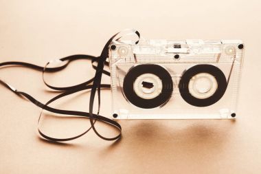 Vintage audio cassette on brown background clipart