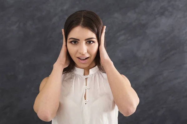 Femme confus met ses mains sur les oreilles — Photo